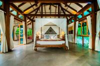 a bedroom with a bed with a canopy at Koh Jum Beach Villas "A member of Secret Retreats" in Ko Jum