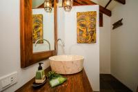 a bathroom with a bowl sink on a wooden counter at Koh Jum Beach Villas "A member of Secret Retreats" in Ko Jum