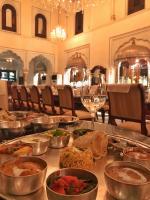 Una mesa con muchos tipos diferentes de comida sobre ella. en The Raj Palace (Small Luxury Hotels of the World), en Jaipur