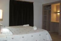 A bed or beds in a room at Hostal La Cabanya
