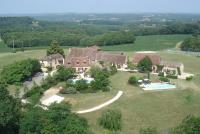 an aerial view of a large house with a swimming pool at Le Domaine des Fargues in Sainte-Foy-de-Longas