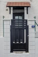 a black door on the side of a building at BtoBed - Studios Paris Le Bourget in Le Bourget