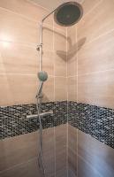 a shower with a shower head in a bathroom at BtoBed - Studios Paris Le Bourget in Le Bourget
