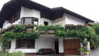 a white house with flowers on the balconies at Ferienwohnung Pupeter in Arzl im Pitztal
