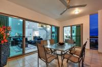 a dining room with a table and chairs at Argus Apartments Darwin in Darwin