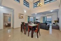 a dining room and living room with a table and chairs at Argus Apartments Darwin in Darwin