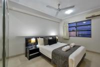 a bedroom with a bed and a window at Argus Apartments Darwin in Darwin