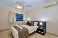 a bedroom with a bed and a window at Argus Apartments Darwin in Darwin