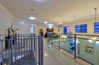 a lobby with glass railing and a staircase at Argus Apartments Darwin in Darwin