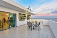 a house with a balcony with a table and chairs at Argus Apartments Darwin in Darwin