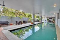a swimming pool in a house with a patio at Argus Apartments Darwin in Darwin