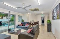 a living room with a couch and a table at Argus Apartments Darwin in Darwin