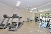 a gym with treadmills and ellipticals in a room at Argus Apartments Darwin in Darwin
