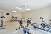 a gym with several exercise bikes in a room at Argus Apartments Darwin in Darwin
