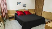 Łóżko lub łóżka w pokoju w obiekcie Hotel Piñupe