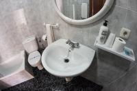 a bathroom with a sink and a toilet and a mirror at Hostal Caminito del Rey in Alora
