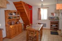 a kitchen with a wooden table and a staircase at Gîte &quot;Entre fraises et mer&quot; in Landrethun-lès-Ardres