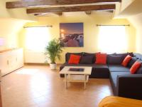 a living room with a blue couch and a table at Pension Roez in Göhren-Lebbin