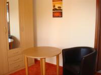 a small table and a chair in a room at Pension Roez in Göhren-Lebbin