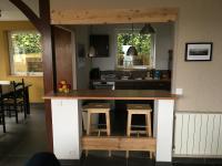 a kitchen with a counter with stools in it at VUE SEINE Chambre Panorama in La Bouille