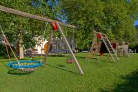 a playground with two swings and a slide at Bauernhofpension Herzog zu Laah in Linz