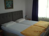 a bed in a bedroom with a large white bed at Pension Balkan in Eisenhüttenstadt