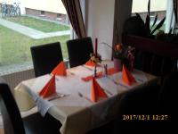 a table with orange flags on top of it at Pension Balkan in Eisenhüttenstadt