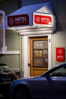 a hotel building with a door and a car parked outside at Hotel Mille Stelle City in Heidelberg