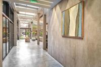 a hallway in a building with a painting on the wall at IOTA Hotel Tbilisi in Tbilisi City
