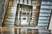 a spiral staircase with a mirror on the wall at IOTA Hotel Tbilisi in Tbilisi City