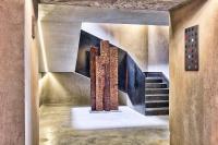 a hallway with a staircase and a painting on the wall at IOTA Hotel Tbilisi in Tbilisi City