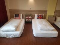 two beds in a room with british flags on them at 角舍背包客棧 -近火車站 in Hualien City