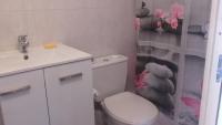 a bathroom with a toilet and a sink and a teddy bear shower curtain at L&#39;oiseau bleu in Salin-de-Giraud