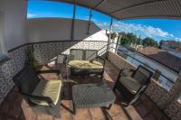 a balcony with two chairs and a table and chairs at Hostal Caminito del Rey in Alora