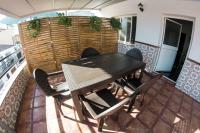 a dining room with a table and chairs on a balcony at Hostal Caminito del Rey in Alora