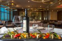 una botella de vino y un plato de comida en una mesa en Catalonia Santo Domingo, en Santo Domingo