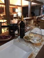 a bottle of wine sitting on a table with wine glasses at Pousada Casa do Catavento in Búzios
