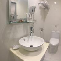 a bathroom with a sink and a toilet at Royal Hotel in Taipei