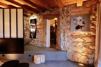 a room with a stone wall with a picture on the wall at Le Clos de Sainte Croix in Lyon