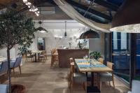 a restaurant with tables and chairs and a bar at Villa Zagórze in Rumia