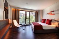 a hotel room with a bed and a large window at Olivia Balmes Hotel in Barcelona