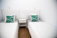 A bed or beds in a room at Las Palmas BEACH