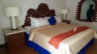 a bedroom with a bed and two lamps and a mirror at Ecotel Quinta Regia in Valladolid