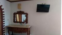 a bathroom with a mirror and a wooden dresser at Ecotel Quinta Regia in Valladolid