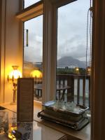 a room with a window with a view of the ocean at Hotel Framtid in Djúpivogur
