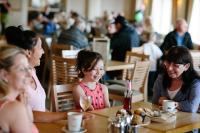 a group of people sitting at a table in a restaurant at Cliffs Hotel in Blackpool