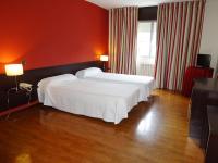 Postel nebo postele na pokoji v ubytování Hotel Millan