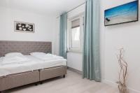 Łóżko lub łóżka w pokoju w obiekcie Apartamenty Aquamarina by Noclegi Renters