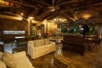 a living room with a couch and a piano at Hotel de Lençois in Lençóis