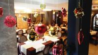 a dining room with a table with christmas ornaments at Family Hotel Delta in Ognyanovo